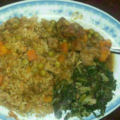 A picture of Pilau with beef stew and green vegetables.