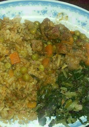 A picture of Pilau with beef stew and green vegetables.