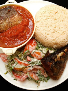 A picture of Rice, stew, fish and salad.