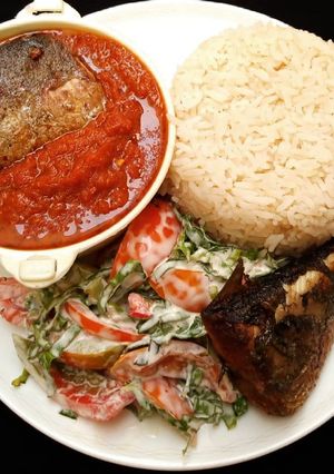 A picture of Rice, stew, fish and salad.