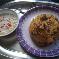 A picture of Mushroom Biryani with Boondi Raita.