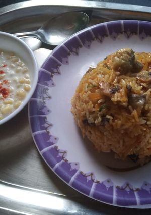 A picture of Mushroom Biryani with Boondi Raita.