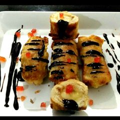 A picture of Banana bread roll with chocolate sauce.