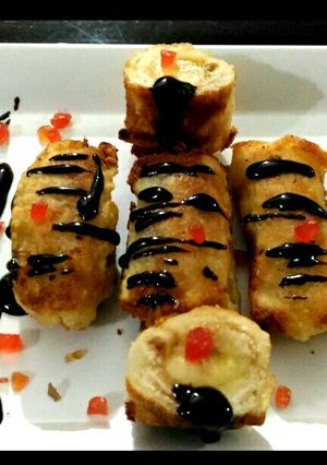 A picture of Banana bread roll with chocolate sauce.