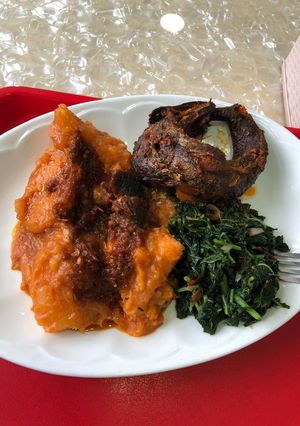 A picture of Yam Porridge and vegetable with smoked mackerel.