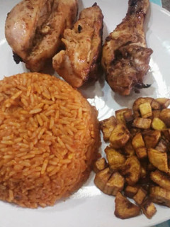 A picture of Jollof rice,fried dodo and fried chicken.