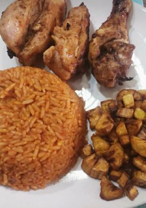 A picture of Jollof rice,fried dodo and fried chicken.