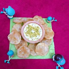 Rice kheer with soft and fluffy puris A picture of Rice kheer with soft and fluffy puris.