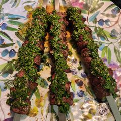 A picture of Steak Kabob with Chimichurri sauce.