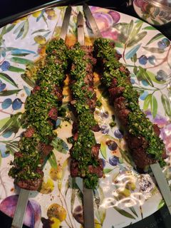 A picture of Steak Kabob with Chimichurri sauce.