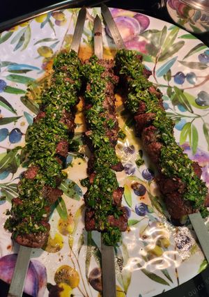 A picture of Steak Kabob with Chimichurri sauce.