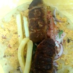 A picture of Turkey kebab with hummus roll.