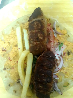 A picture of Turkey kebab with hummus roll.