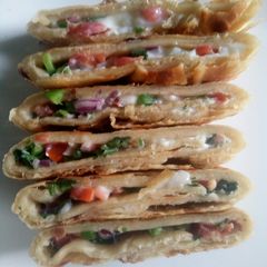 A picture of Spicy omelette stuffed 'roti'.
