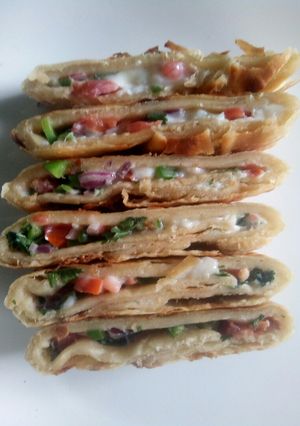 A picture of Spicy omelette stuffed 'roti'.
