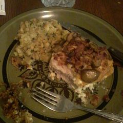 A picture of Parmesan crusted pork chops w/bacon bits and garlic mushrooms.