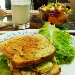 Egg sandwich with fruit salad and almond pumpkin seeds milkshake A picture of Egg sandwich with fruit salad and almond pumpkin seeds milkshake.