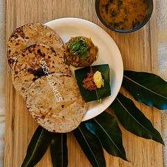 Maharashtrian Lunch Thali of Bhakri, Vangyache Bharit, Phodniche Varan, Gul aani Tup A picture of Maharashtrian Lunch Thali of Bhakri, Vangyache Bharit, Phodniche Varan, Gul aani Tup.