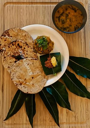 A picture of Maharashtrian Lunch Thali of Bhakri, Vangyache Bharit, Phodniche Varan, Gul aani Tup.