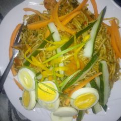 A picture of Spaghetti with veggies and egg.