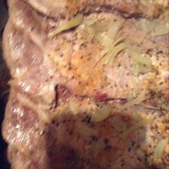 A picture of Bake pork steak with onions .