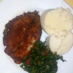 A picture of Deep fried fish with kales an Ugali.