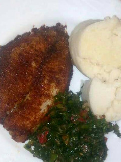 A picture of Deep fried fish with kales an Ugali.