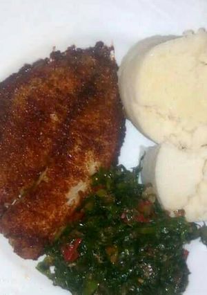 A picture of Deep fried fish with kales an Ugali.