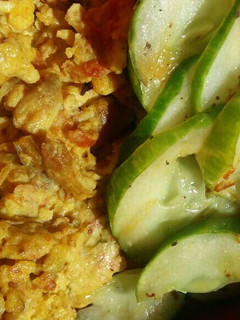 A picture of Scrambled eggs and stir fried cucumber.