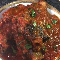 A picture of Curry leaf stew with fried goat meat.