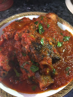 A picture of Curry leaf stew with fried goat meat.