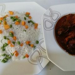 A picture of Veggie Basmatti white Rice and Goatmeat Stew.