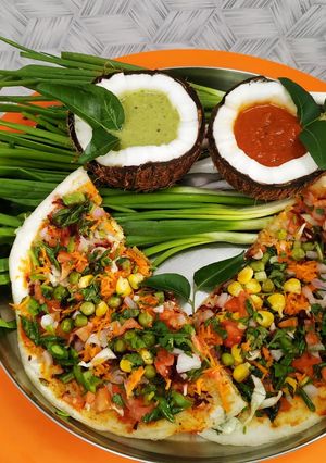 A picture of Veg Dosa wth Coconut CHUTNEY.