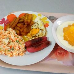 A picture of Fried plantain with fried egg,sausages and custard.