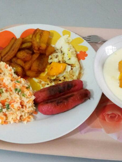 A picture of Fried plantain with fried egg,sausages and custard.