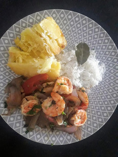Una foto de Saltado de langostinos con yuca y arroz blanco