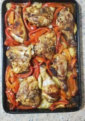 A picture of Baked chicken with pineapples and capsicums (bell pepper).