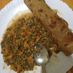 A picture of Brown chappatis served with green grams.