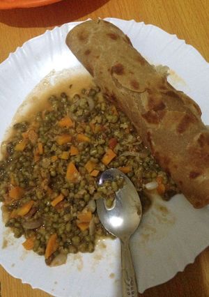 A picture of Brown chappatis served with green grams.