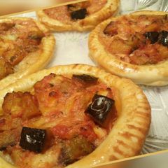A picture of Aubergine and mozzarella mini pies.