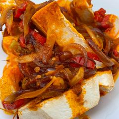 A picture of Oven roasted yam with native palm oil sauce.