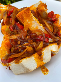 A picture of Oven roasted yam with native palm oil sauce.