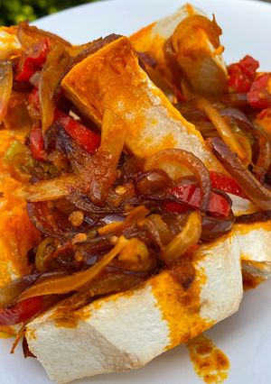 A picture of Oven roasted yam with native palm oil sauce.