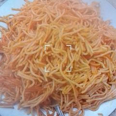 A picture of Jollof spaghetti with leftovers stew.