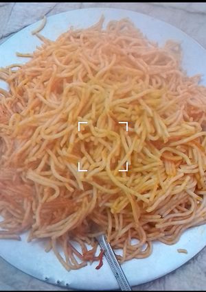 A picture of Jollof spaghetti with leftovers stew.