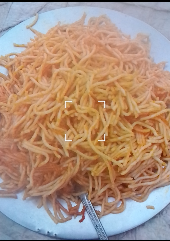 A picture of Jollof spaghetti with leftovers stew.