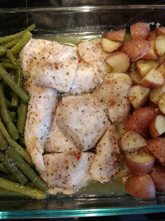 A picture of Baked chicken, green beans and red potatoes.