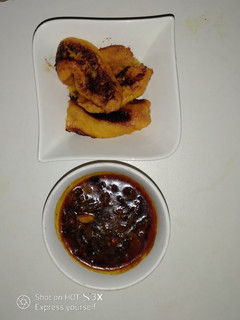 A picture of Pan Roast ripe plantain and crayfish sauce.
