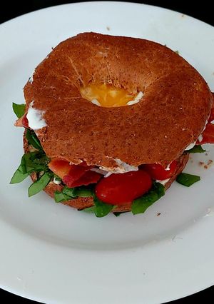 A picture of My Crispy Bacon on Wholemeal 🥯 with 🍅 and 🥚 also Spinach.