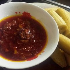 A picture of Palm oil sauce with plantain.